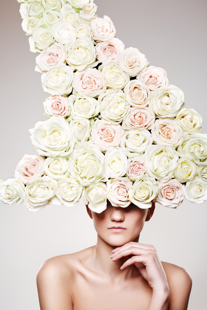 Beautiful woman with a rose headwear in a model pose - Фото, зображення