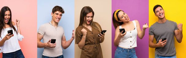Set of people over colorful background with phone in victory position - 写真・画像
