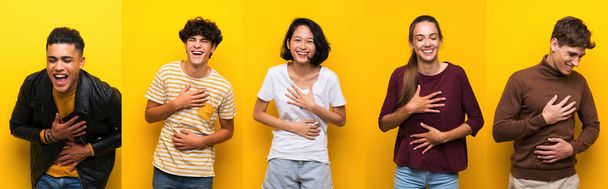Set of people over isolated yellow background smiling a lot - Photo, Image