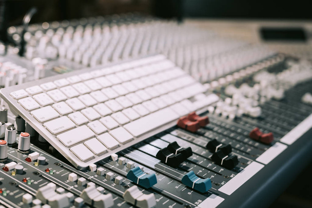 white keyboard on audio mixing console, computer in digital recording, broadcasting technology concept - Photo, image