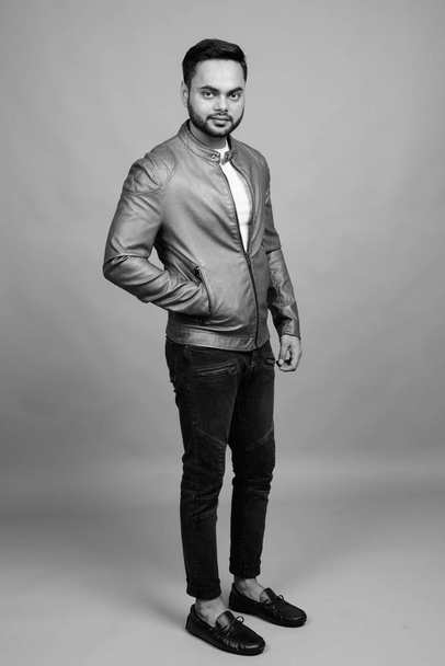 Young bearded Indian man against gray background - Foto, Imagem