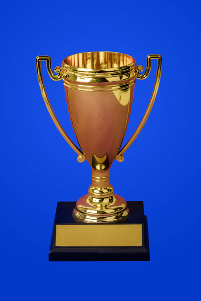 Golden trophy cup on blue - Fotoğraf, Görsel