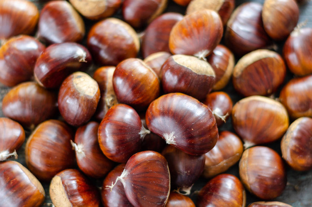Edible chestnuts on the  wooden table. - Photo, Image