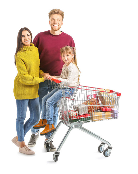 Family with shopping cart full of Christmas gifts on white background - Foto, afbeelding