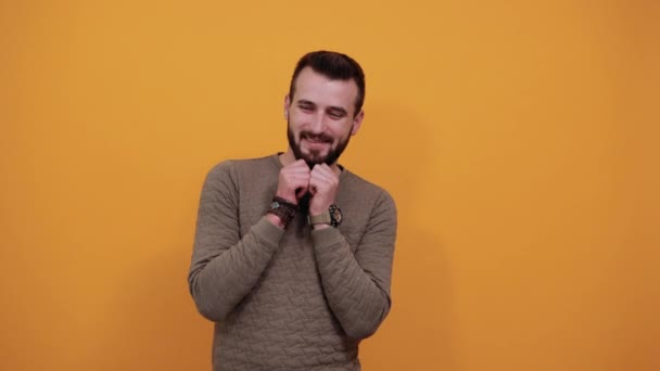 Handsome man keeping hands on cheeks, beard, smiling, looking happy - Filmagem, Vídeo