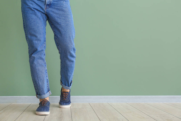 Young man in stylish shoes near color wall - Foto, immagini