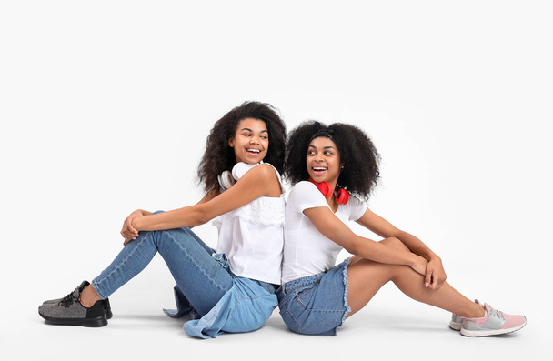 Portrait of young African-American women on white background - Photo, Image