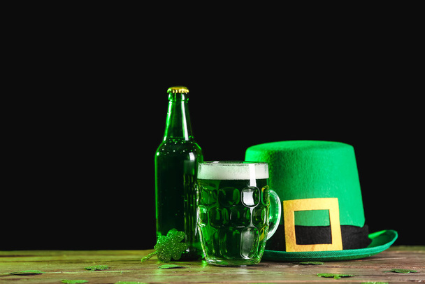 Green beer and Leprechaun's hat on table. St. Patrick's Day celebration - Фото, изображение
