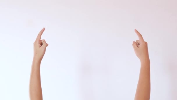 Hands raised, pointing to an empty area to create a white background feature - Footage, Video