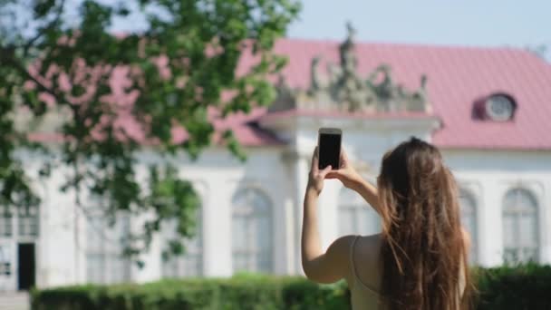 Woman tourist taking pictures of old classic architecture building - Footage, Video