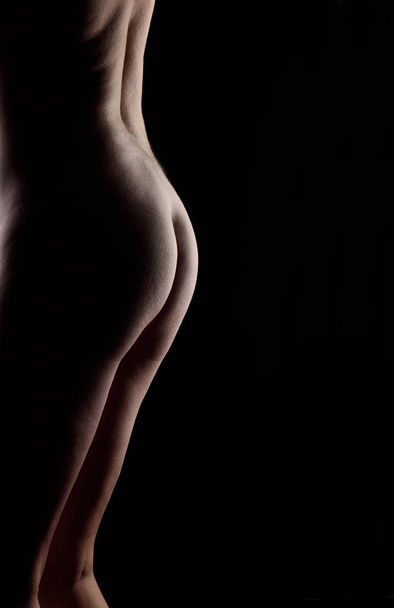 nude body of middle aged woman on black background - Zdjęcie, obraz