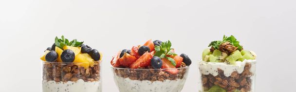 fresh granola with fresh fruits and berries isolated on grey - Фото, изображение