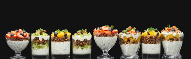 fresh granola with fresh fruits and berries isolated on black, panoramic shot - Photo, Image