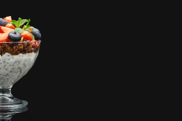 friss müzli bogyókkal és chia magokkal, fekete alapon izolálva - Fotó, kép