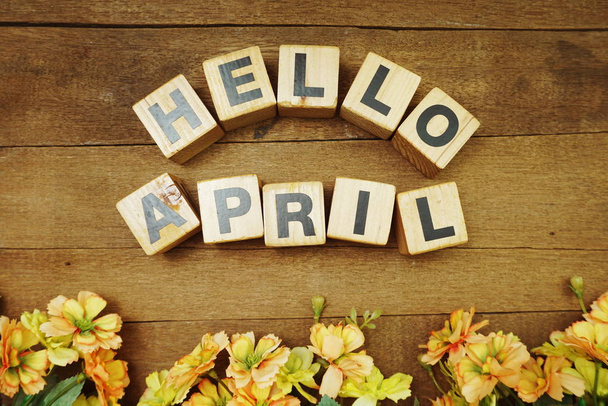 Hello April alphabet letter and flower decoration with space copy on wooden background - Photo, Image