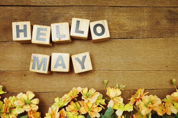 Hello May alphabet letter and flower decoration with space copy on wooden background - Fotó, kép