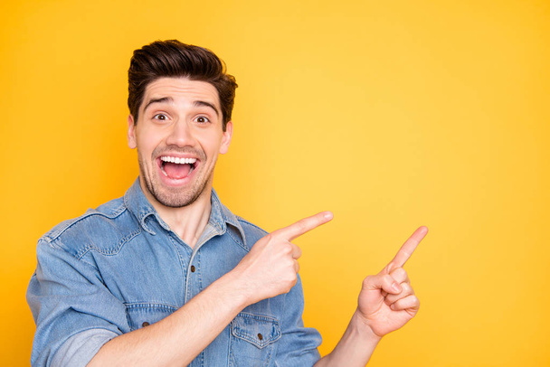 Photo of excited ecstatic overjoyed man screaming pointing into empty space at sales with astonishment on face isolated vivid color background - Foto, Bild
