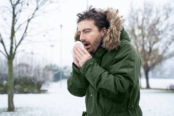 Man coughing and suffering in cold winter weather - 写真・画像