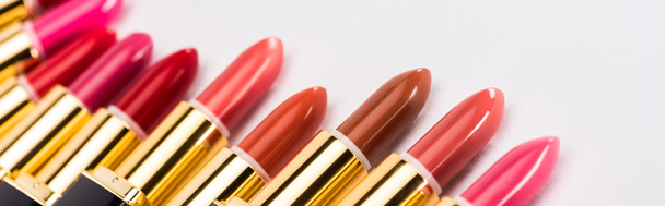 close up view of assorted lipsticks in luxury tubes on white background, panoramic shot - Φωτογραφία, εικόνα