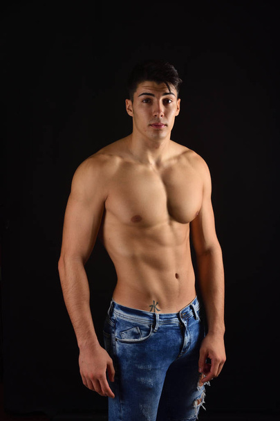 portrait of young man with  torso naked with jeans on black back - Foto, Imagem