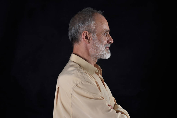 portrait of middle aged man on black - Foto, Bild
