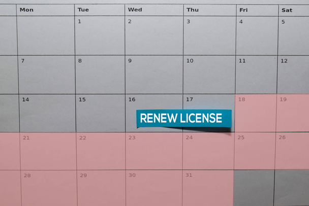 Renew License write on Sticky Note above calendar. Reminder or Schedule Concepts - Photo, Image