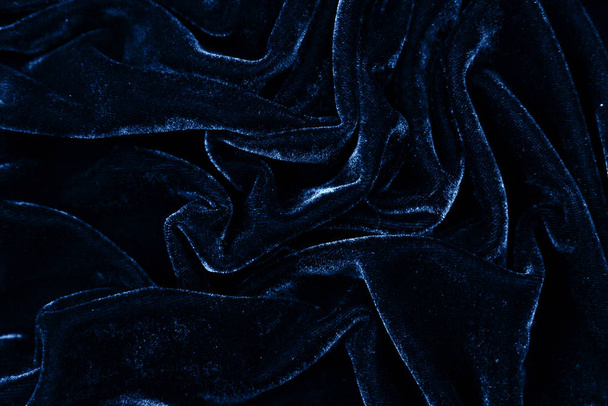 drity blue fabric closeup. Velvet texture background. Classic blue color of year 2020. - Fotó, kép