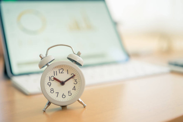 Vintage White Alarm Clock on on a NoteBook. It's time to rest. u - Foto, imagen