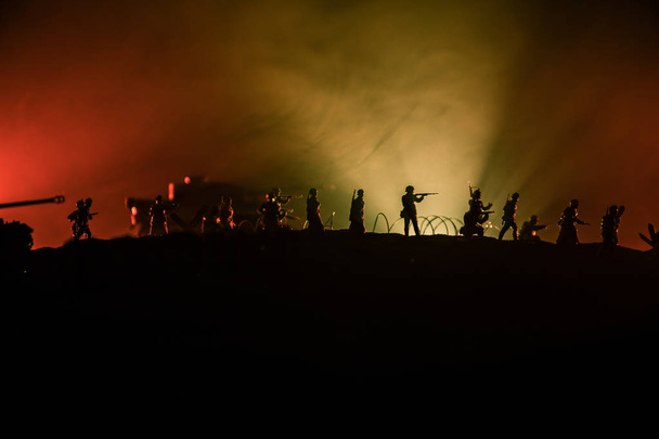 War Concept. Military silhouettes fighting scene on war fog sky background, World War German Tanks Silhouettes Below Cloudy Skyline At night. Attack scene. Armored vehicles and infantry. - Photo, image