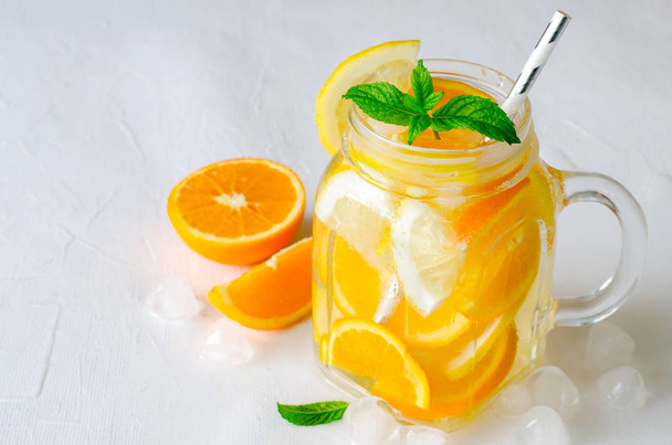 Summer refreshing iced drinks with orange, lemonand mint on white background - Фото, зображення