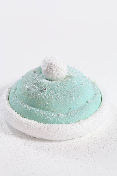 "Winter Hat" Cake - Contemporary Multi-Layered Mousse Cake with bird cherry sponge cake, black currant cream and jam, vanilla mousse with sour cream, covered with light blue velvet spray, on white background. - 写真・画像