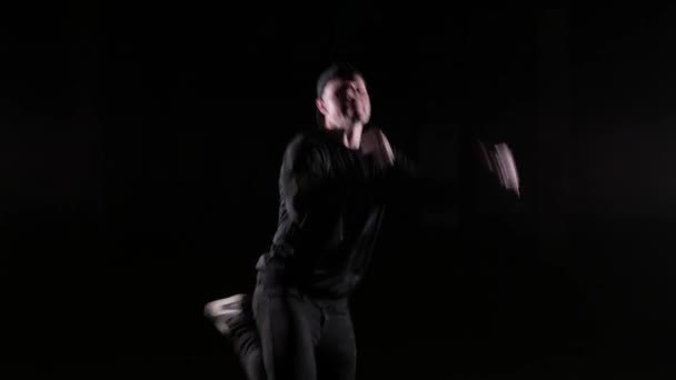 Young guy dancing breakdance, hip hop, street dancing in the studio, isolated - Materiał filmowy, wideo