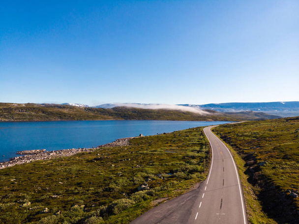 Road crossing Hardangervidda plateau, Norway. Aerial view. - Фото, изображение