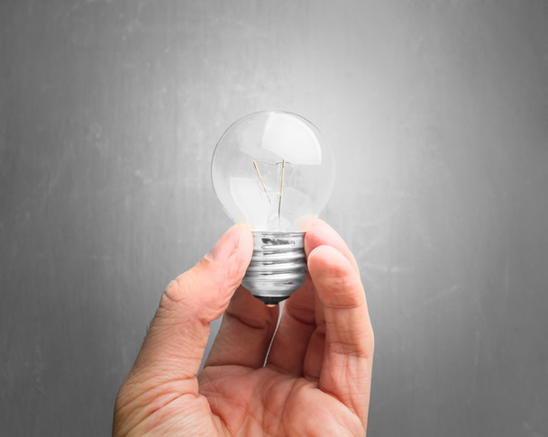 Light bulb in hand close-up - Фото, зображення