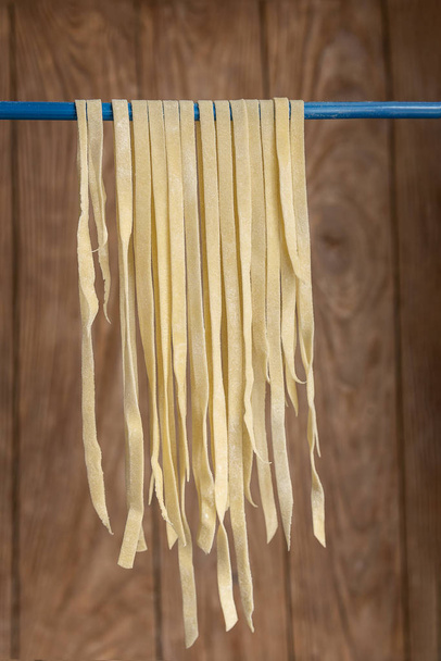 Vertical view of haning tagliatelle to dry - Photo, Image