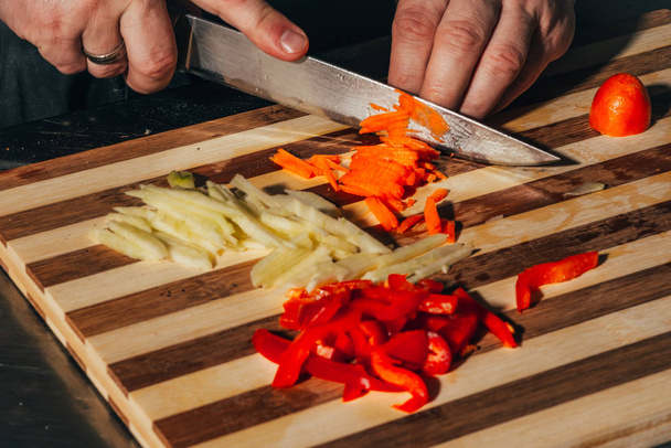 cutting carrot and red bell paper - Photo, Image