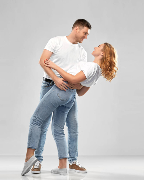 portrait of happy couple in white t-shirts dancing - Foto, afbeelding