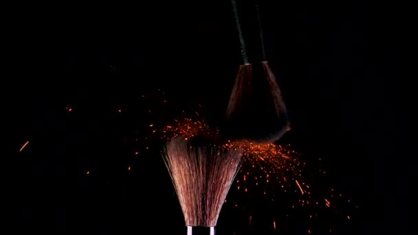 Two makeup brushes with bright eye shadow. Glitter and shadows scatter in the air - Felvétel, videó