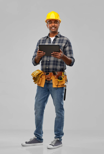 happy indian builder in helmet with tablet pc - Fotó, kép