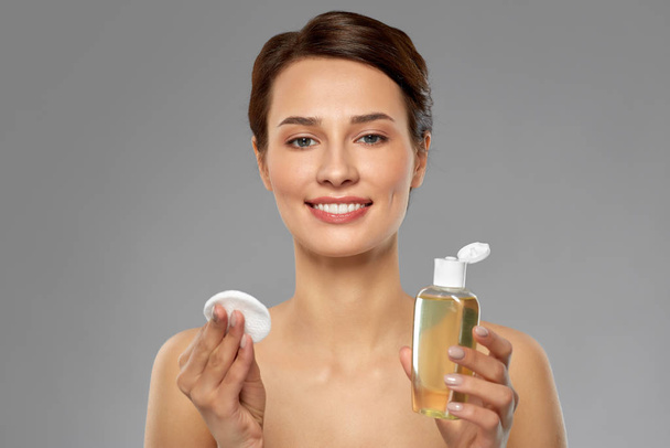 young woman with toner or cleanser and cotton pad - Foto, Bild