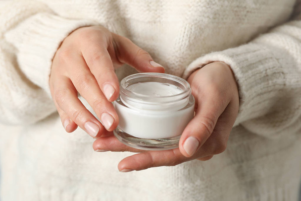 Woman holding jar of moisturizing cream, closeup. Winter cosmeti - Fotografie, Obrázek