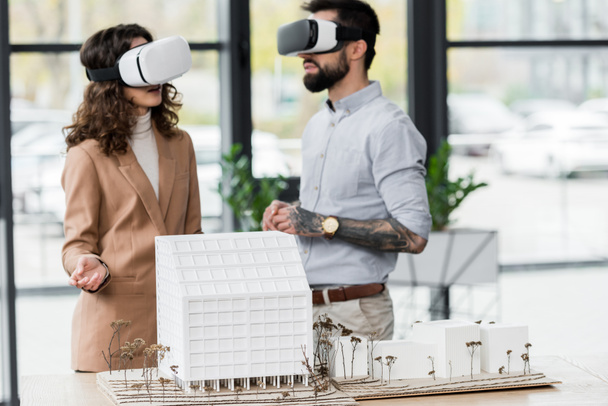 virtual reality architects in virtual reality headsets talking in office  - Foto, immagini