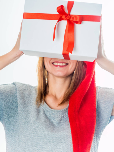 Young woman holding gift box behind her face - Fotoğraf, Görsel