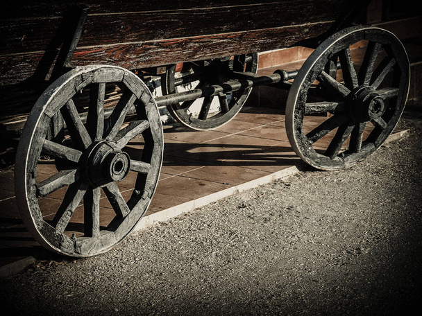 Carro de madera viejo con grandes ruedas de hierro negro primer plano
 - Foto, imagen
