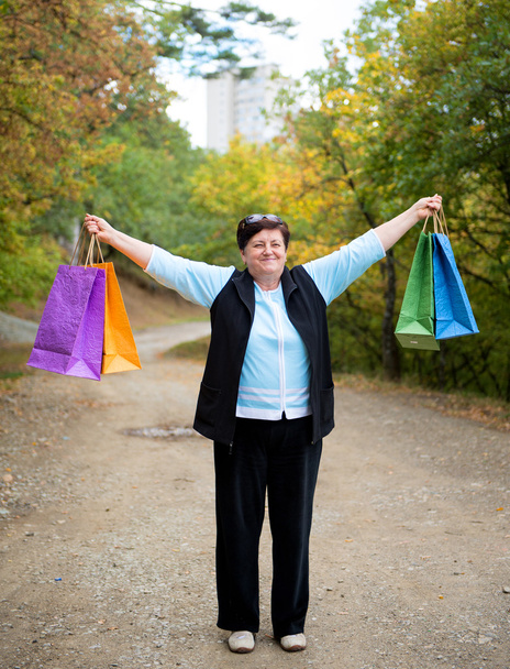 Mujer con bolsas de compras en la calle
 - Foto, imagen