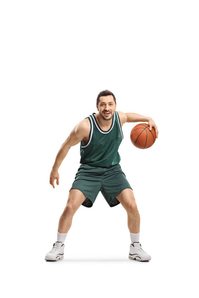 Man in green jersey playing basketball  - Фото, изображение
