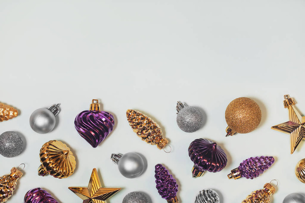 Vintage Christmas tree baubles decorative background. Silver, purple, and golden old fashioned ornaments. Glass pine cones, stars balls. Horizontal New Year bright backdrop with copyspace. - Photo, Image