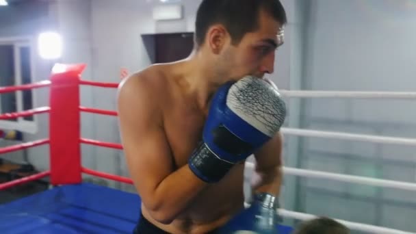 Boxing training - two athletic men having an aggressive fight on the ring - Video