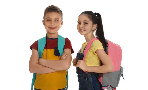 Little school children with backpacks on white background - Фото, изображение