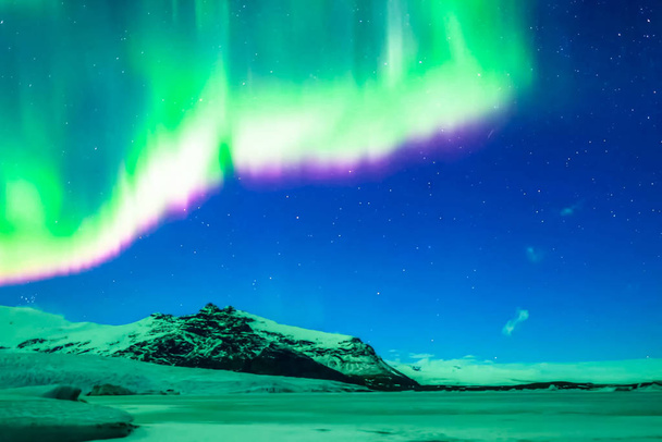 Aurora borealis yötaivaalla. Ilman hiukkasten ionisaatio ylemmässä ilmakehässä
. - Valokuva, kuva